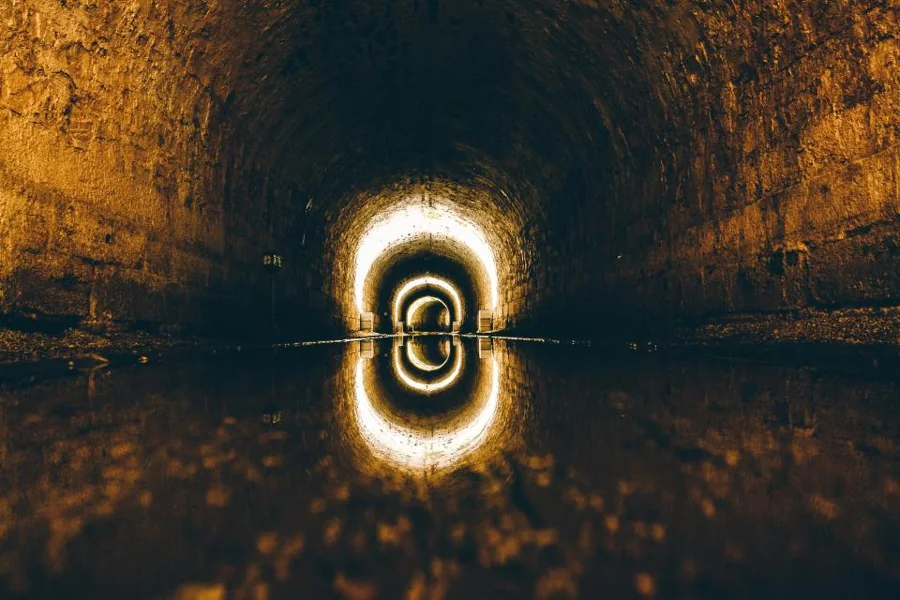 The inside of a large pipe lit at the far end